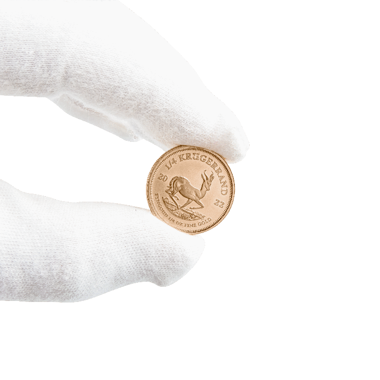 Gold Krugerrand coin in hand 1/4 troy ounce